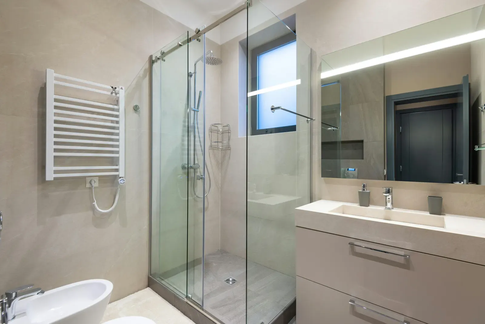 Salle de bain rénovée par SDR Habitat 44 avec douche à paroi vitrée et meuble vasque